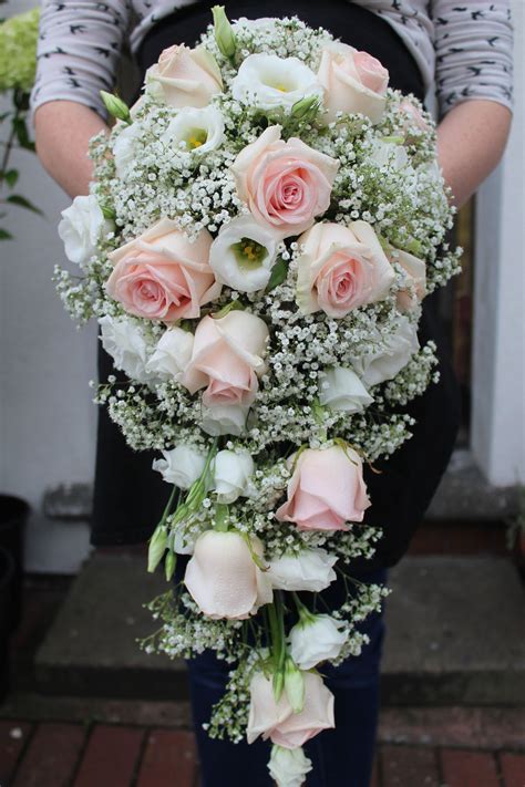 Elegant blush pink and white tear drop bouquet including roses, lizianthus and gypsophil ...