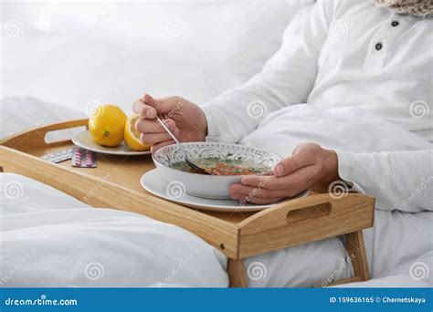 Sick Young Man Eating Soup To Cure Flu in Bed at Home Stock Image - Image of male, fruit: 159636165