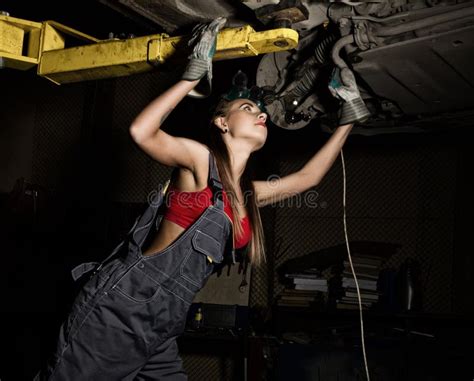 Beautiful Young Female Mechanic Inspecting Car in Auto Repair Shop ...