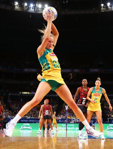 Australian netballer jumps up to grab the ball - nice green spandex ...