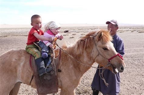 Mongolian children having fun on their horse. They use to ride horses ...