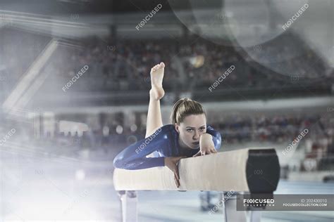 Female gymnast practicing on balance beam in arena — Soft Focus ...