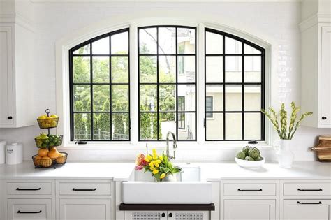 Three arch casement windows over a farmhouse sink finished in black ...