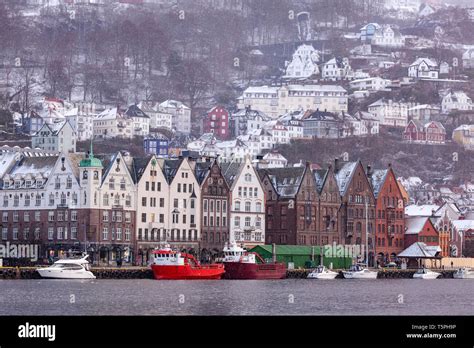 Snow falling at Bryggen and Vaagen, in the inner port of Bergen, Norway ...