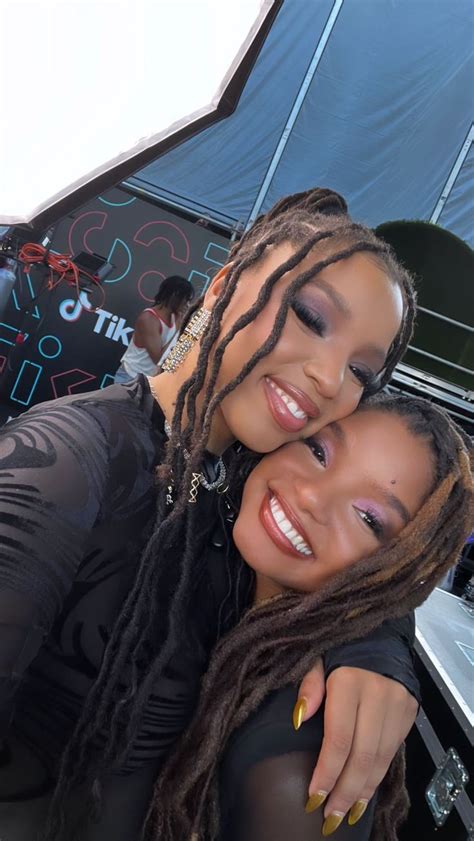 two women with dreadlocks hugging each other