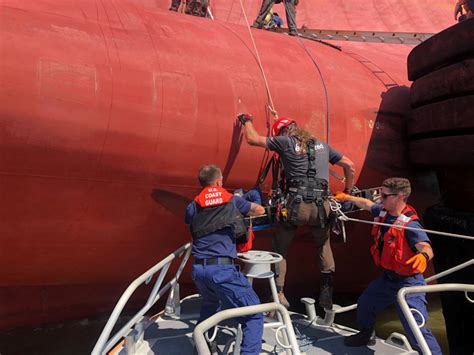 Crewmen on capsized cargo ship rescued from ‘worst possible conditions’ | PBS NewsHour