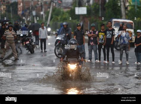 Kathmandu, Nepal. 23rd July, 2023. A motor rider makes his way through ...