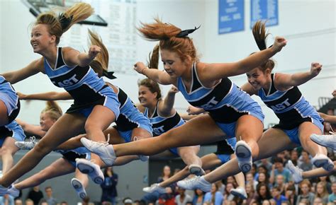 The varsity cheerleaders perform a routine with a series of jumps at the fall pep assembly ...