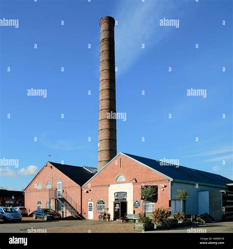 A tall industrial chimney above Victorian era factories Stock Photo - Alamy