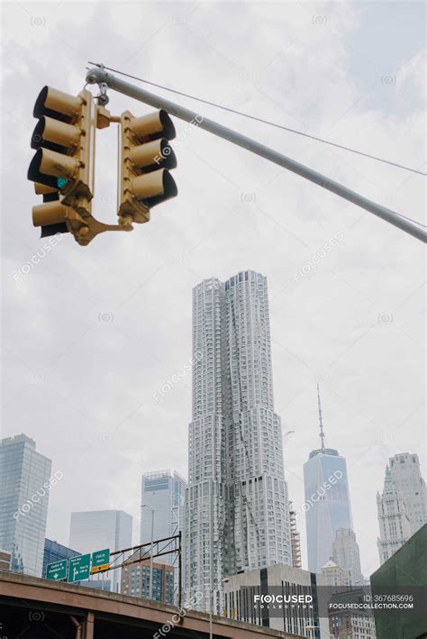 From below of traffic light hanging over road in New York City with contemporary skyscrapers and ...