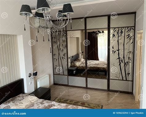 Designer Bedroom with Black Chandelier Stock Photo - Image of home, illumination: 169623294