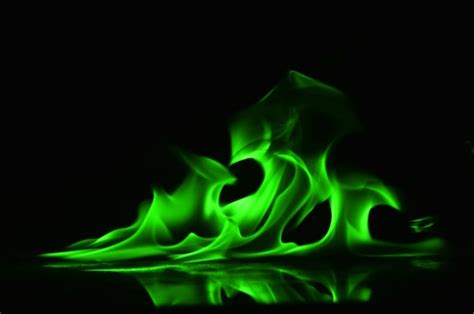 Premium Photo | Abstract Green fire flames on black background