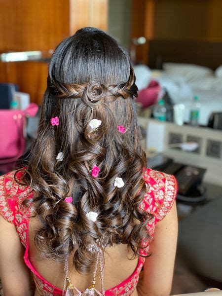 Photo of Open hairstyle with soft curls and flowers.