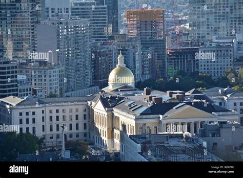 The gold dome of the Massachusetts State House atop Beacon Hill against the downtown Boston ...