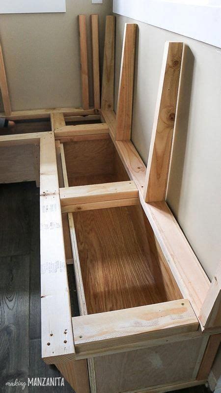 Interior framing and plywood boxes for storage inside this banquette booth seating in brea ...