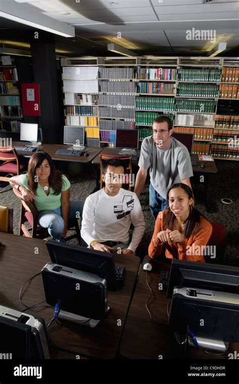 College students using computers in the library Stock Photo - Alamy