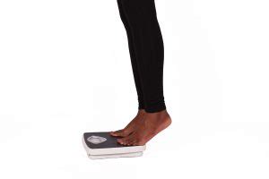 Legs of Woman Stepping on Weigh Scale to Measure Weight - High Quality Free Stock Images
