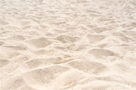 Premium Photo | Sand on the beach for background. brown beach sand texture as background. close-up.