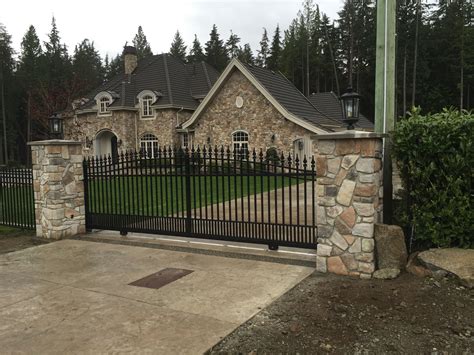 Stone pillars with sliding gate and lights | House gate design, Stone ...