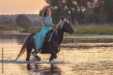 Girl riding horse on water surface Stock Photo | Adobe Stock