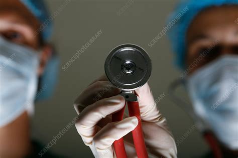 Surgeon stands next to her assistant - Stock Image - C053/1135 ...