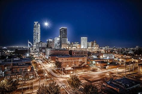 Download Illuminating Iconic Oklahoma Cityscape Wallpaper | Wallpapers.com