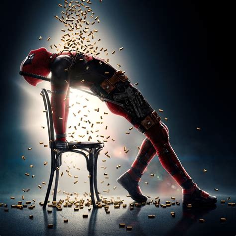 a deadpool character sitting on a chair surrounded by gold flakes in ...