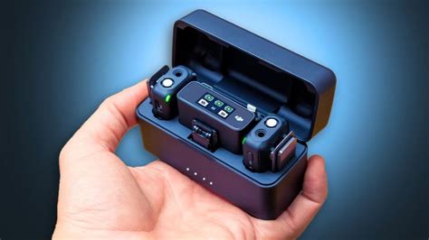 a hand is holding an electronic device in its case with buttons and lights on it