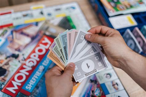 Faceless player with fake banknotes playing table game · Free Stock Photo