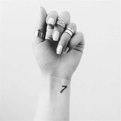 Number seven tattoo on Anuka's wrist.