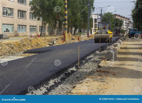 An Asphalt Paver and a Roller are in Operation Stock Photo - Image of ...