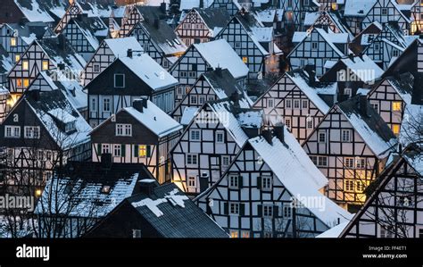 Dreamily scene of a winter village in germany with snow covered roofs ...