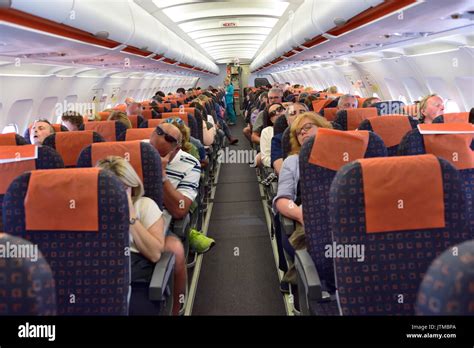 Inside commercial airplane cabin during flight with passengers mainly sleeping Stock Photo - Alamy