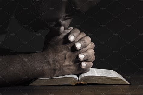 Man praying to God on a Bible | Holiday Stock Photos ~ Creative Market