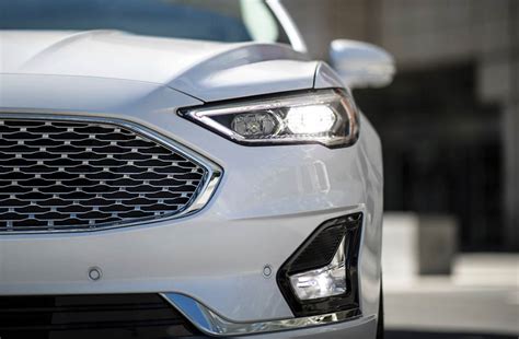 How to activate auto headlights with wipers on Ford Fusion