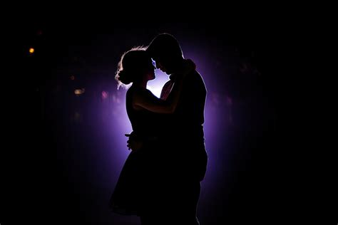 Silhouette of a romantic couple dancing and enjoying in the dark ...