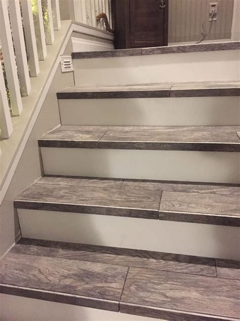 some stairs that have been painted white with wood flooring on the bottom and bottom