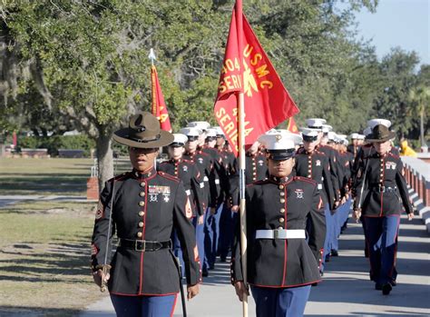 First company graduates in new dress blue uniform for female Marines