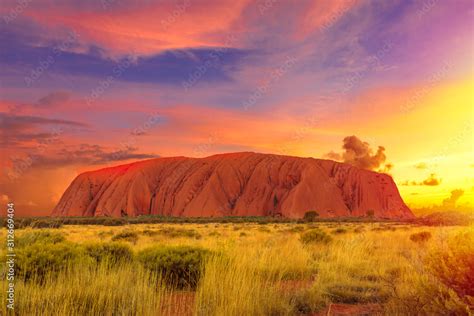 Colorful clouds at sunset sky over Ayers Rock in Uluru-Kata Tjuta ...