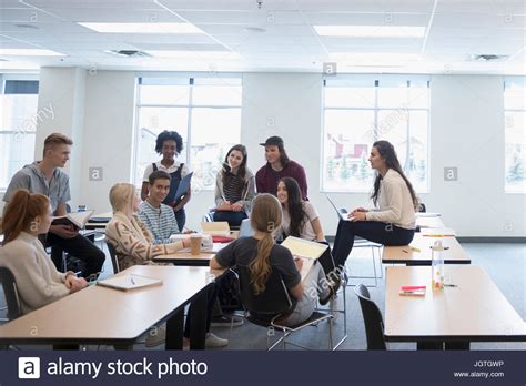 College students talking in group in classroom Stock Photo - Alamy