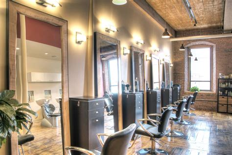 a hair salon with lots of chairs and mirrors