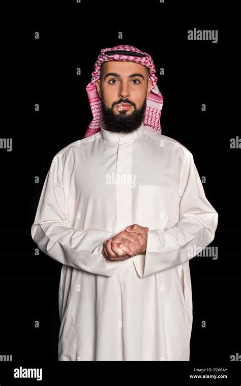 handsome man in traditional muslim clothing isolated on black Stock ...