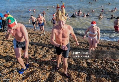 People, dressing Santa hats and outfits for the festive swim, take ...