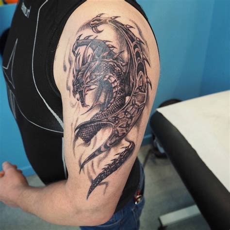 large-dragon-shoulder-tattoo-man-wearing-a-black-top-jeans-forearm-tattoos-for-men | Tattoos for ...