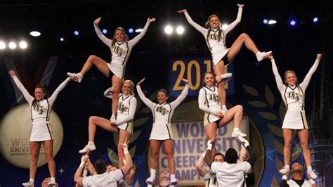 a group of cheerleaders doing stunts on stage