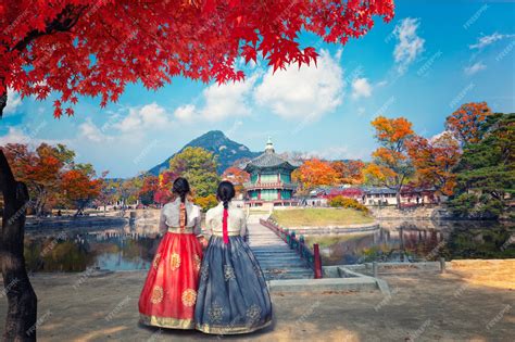 Premium Photo | Gyeongbokgung palace in autumn with Korean national dress