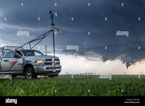 A storm chaser science research truck with CWSR parks near a developing ...