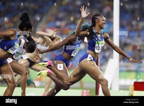 Brianna Rollins (far R) of the United States crosses the finish line to ...