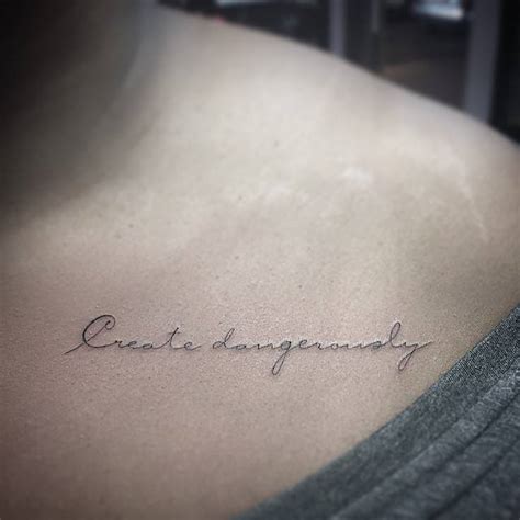 "Create dangerously" tattoo on the left side of the