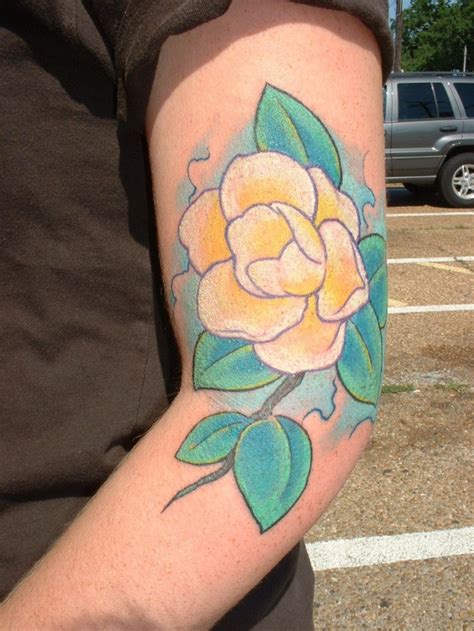 Cute yellow magnolia flower tattoo on arm - Tattooimages.biz